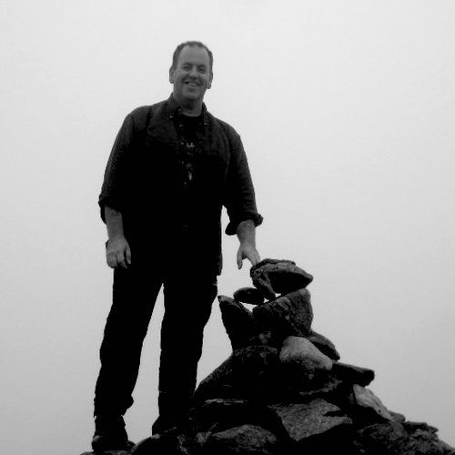 Artist Ade Hughes on a mountain top